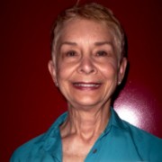 Smiling older woman with a gray-blonde pixie cut